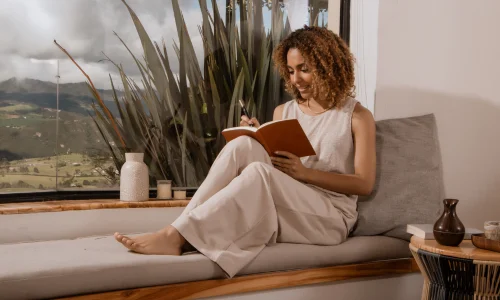 Woman Journaling By Window